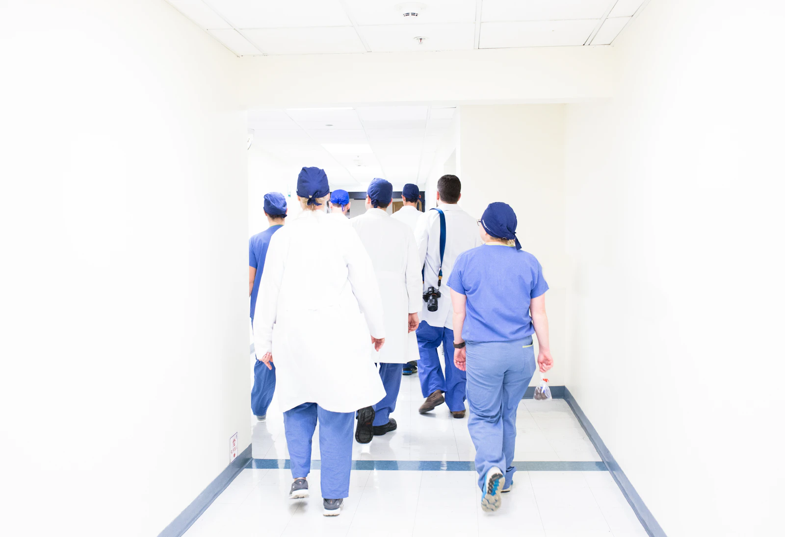 Multidisciplinary medical team moving through a hospital corridor